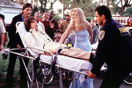 As a worried Mary (Cameron Diaz) looks on, Ted (Ben Stiller) is carried to an ambulance after an accident involving his "family jewels."