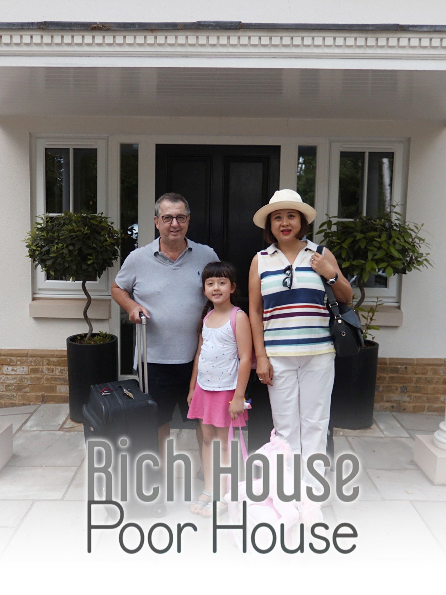 rich family in front of house